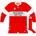 1995:
Wider hoop, allowing the Sperrin logo to be easier included. Oddly, the GAA logo was in blue and gold, however.