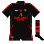 2011-12:
Down met Cork again in the  All-Ireland qualifiers and rather than use the traditional gold change jerseys, an all-black kit was used for the first time in almost 30 years. Essentially the same design as the goalkeeper kit, this shirt featured a collar.