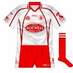 2004-07:
Celebrating being All-Ireland senior champions for the first time, Tyrone introduced this jersey for the 2004 season. The main changes were the narrow red stripes on the sides of the body and on the sleeves, while Rocwell became the new sponsors.2004-